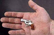 Does the smallest handgun fire on the world have how old?