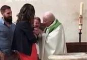 The priest cries loudly to be overcome when infantile baptize direct one a slap on the face